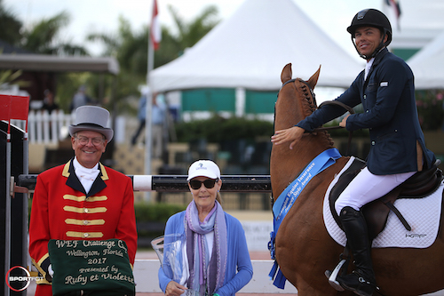 Kent Farrington and Creedance in their winning presentation with ringmaster Steve Rector and Laura Fetterman of Champion Equine Insurance.